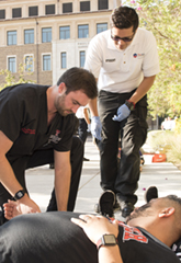 medical professionals helping mock patient