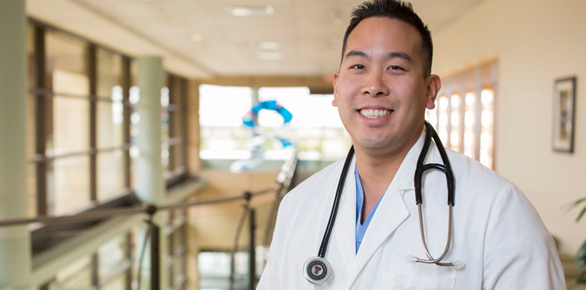 Student in white coat with stethoscope