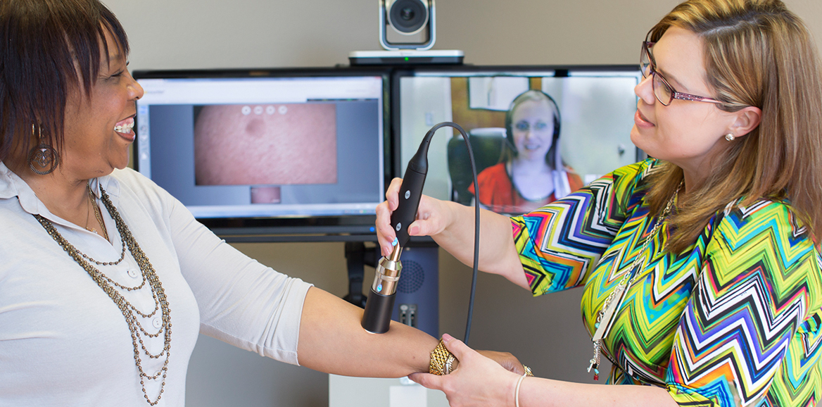 two females, using equipment, computer monitor with camera