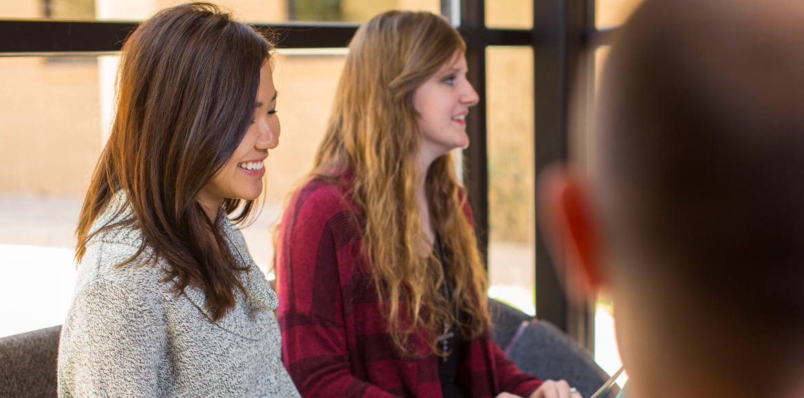 two female students sitting in study area