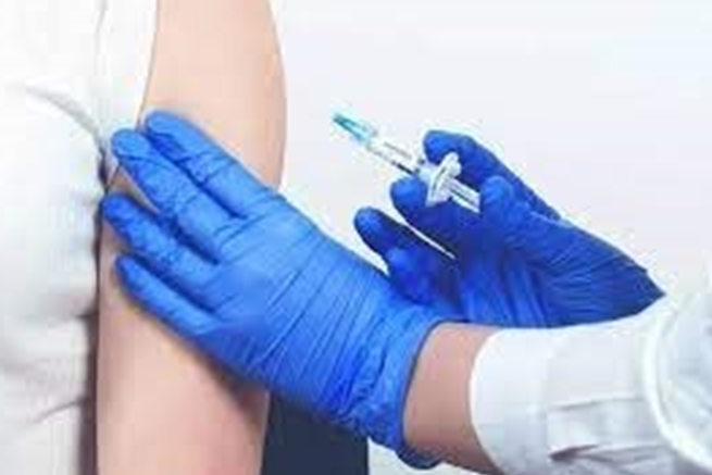 physician giving patient a shot