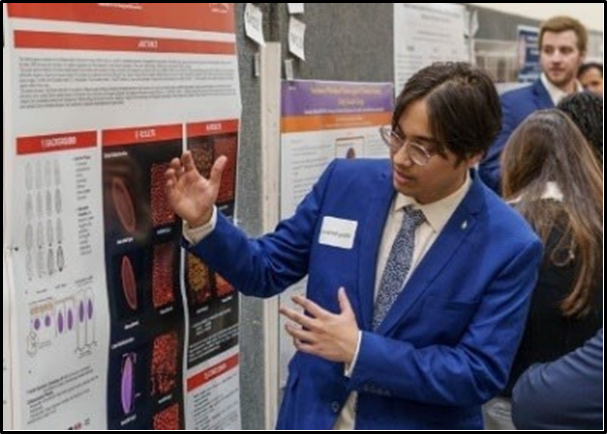 student presenting poster at research week