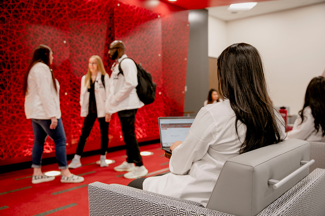 Health professions students standing in lobby of Midland location