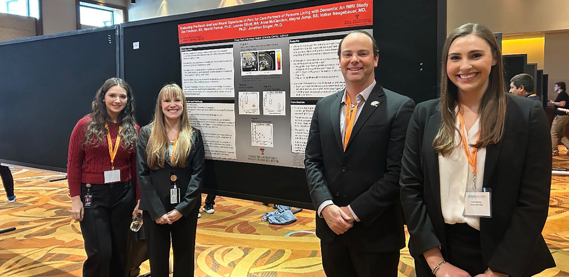 Garrison Instititue on Aging team of researchers standing infront of a presentation board at an event smiling