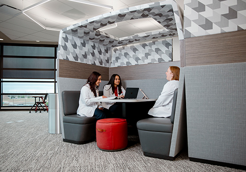 Three TTUHSC students sitting in a booth study area in the library