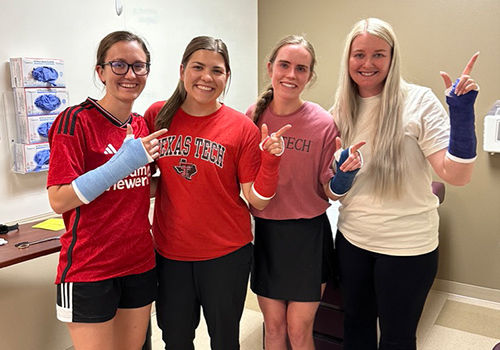 TTUHSC students standing with guns up fingers pointed with temporary casts on TTUHSC students standing with guns up fingers pointed with temporary casts on