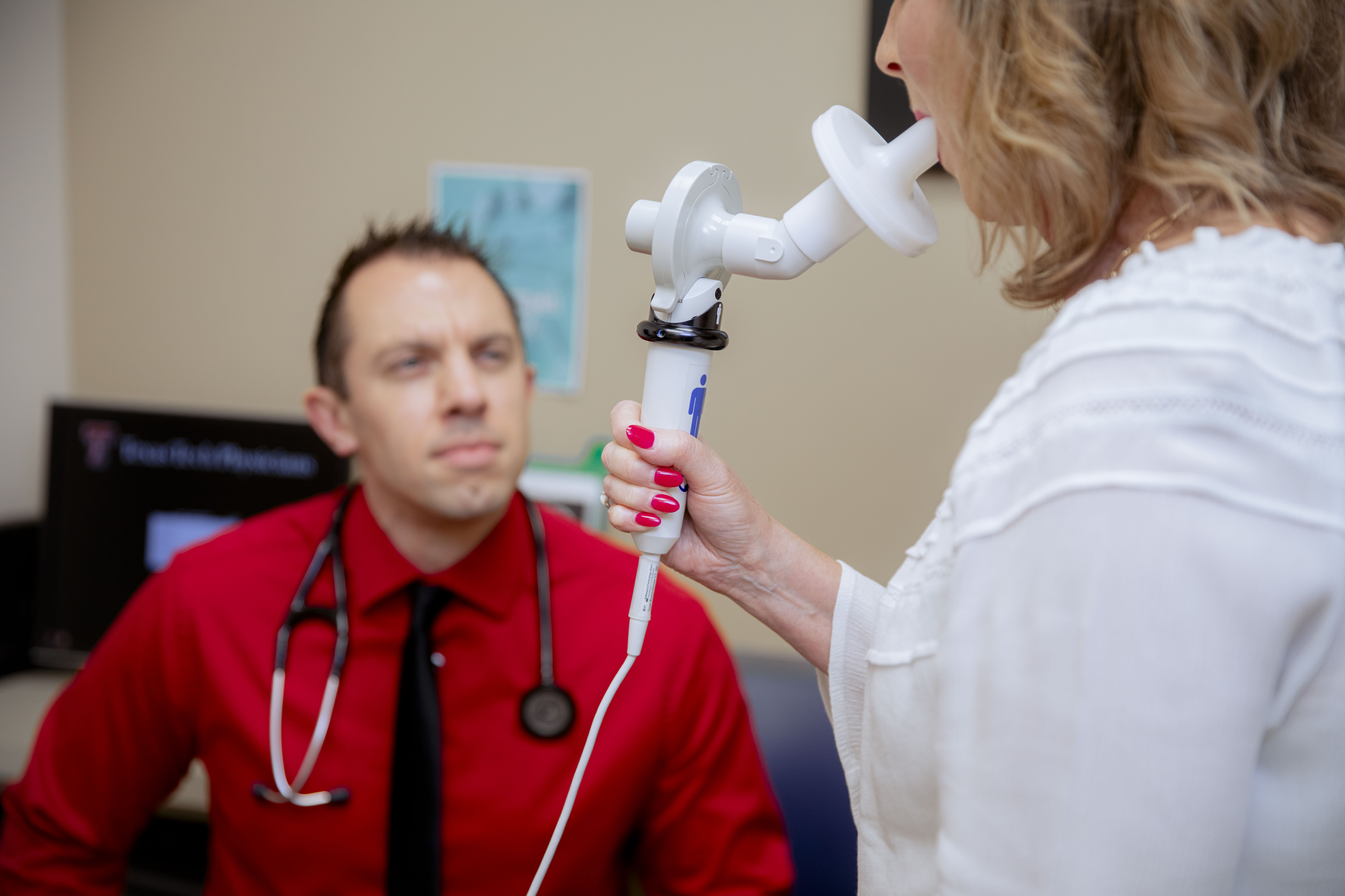 Male physician helps a client through a procedure