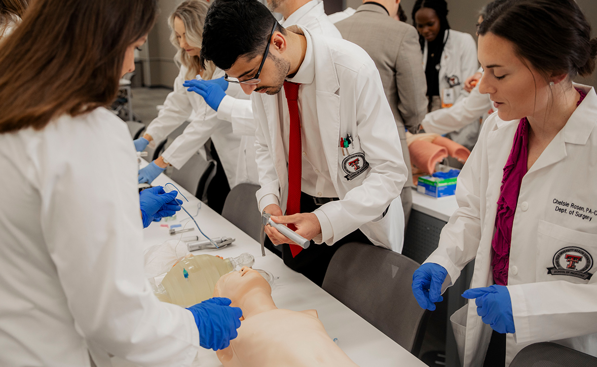 Surgery residents at Texas Tech University Health Sciences Center practice hands-on skills during a simulation lab, gaining experience in patient care procedures under faculty guidance.