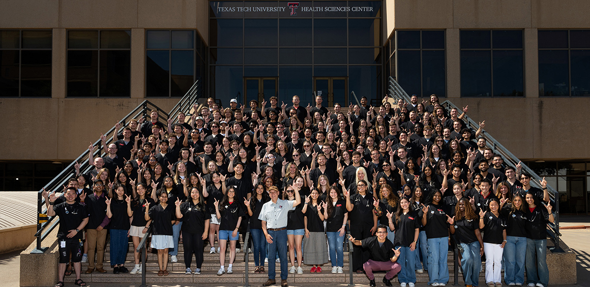 2026 Scopes and Scrubs photo of students standing infront of TTUHSC Lubbock stairway