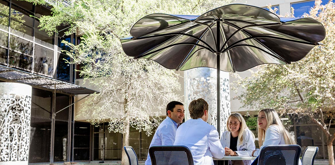 School of Medicine students sitting at a table outside of the Lubbock Campus