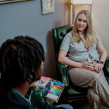 student and counselor in a room sitting