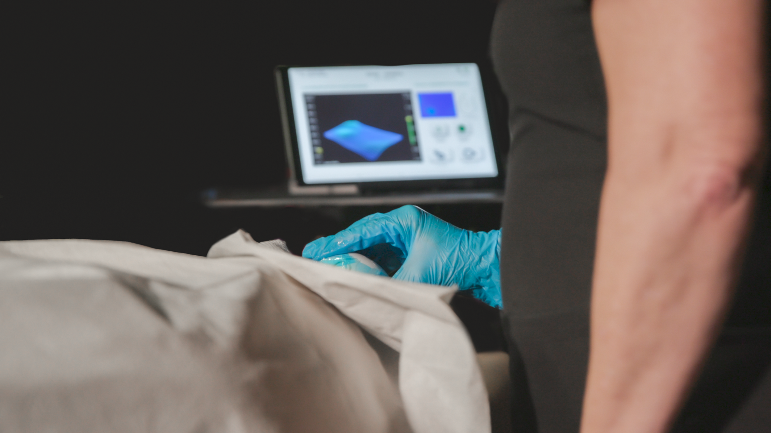 Technician performs Bexa ultrasound test with visible screen