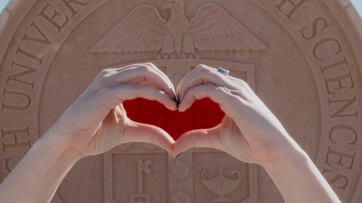 Hands in heart shape in front of TTUHSC Seal