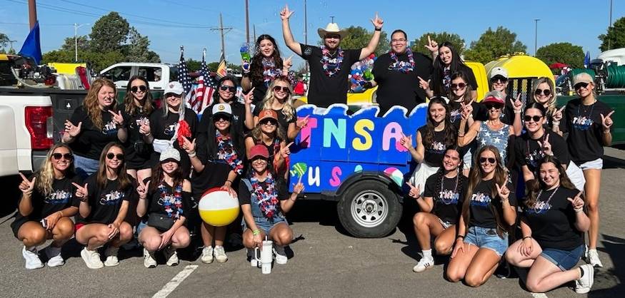 TNSA Amarillo students posing on their float